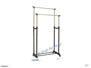 Two adjustable black metal garment racks with gold hanging rails.