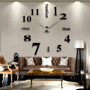 Modern large black wall clock decal with numbers and words in a living room setting.