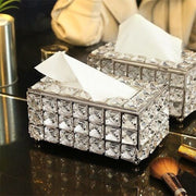 Two luxurious crystal rhinestone tissue box covers with white tissues on a reflective surface