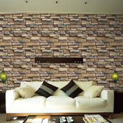 White living room sofa against a faux stone brick wallpaper wall with accent lamps.