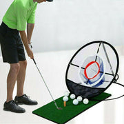Man practicing golf swings with a portable target net and artificial grass mat.