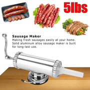 Stainless steel sausage maker machine with various cooked sausages on a wooden surface.