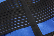 Close-up of black elasticated fabric straps on a blue textured material.