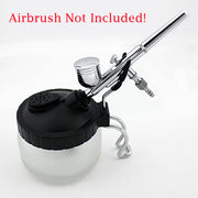 Professional airbrush spray gun with paint reservoir and nozzle attachment.