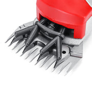 Red and silver electric hair clipper with professional metal cutting blades.