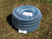 Coiled blue corrugated flexible hose with white connectors on grass
