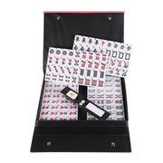Mahjong tile set with scoring sheets and dice in a black carrying case