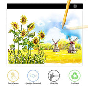 Digital drawing tablet displaying a sunflower and windmill landscape painting.