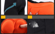 Close-up of padded orange cycling shorts showing breathable mesh fabric and cushioned padding.