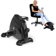 Under desk pedal exerciser being used by a woman sitting in an office chair.
