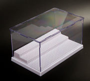 Clear acrylic display case with white tiered stepped base for product showcase.