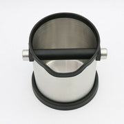 Stainless steel milk frothing pitcher with a black handle and base