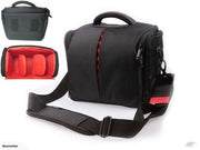 Black padded camera bag with adjustable shoulder strap and red interior lining