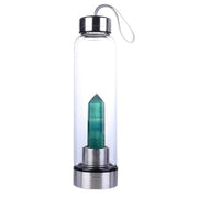 Transparent glass water bottle with a green crystal gemstone infusion point