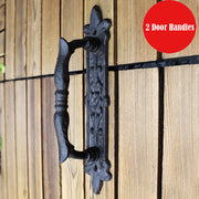 Vintage black cast iron ornate door handle mounted on a wooden door