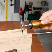 Hand using a gold rotary tool with a cutting disc to carve a slot in a piece of wood.